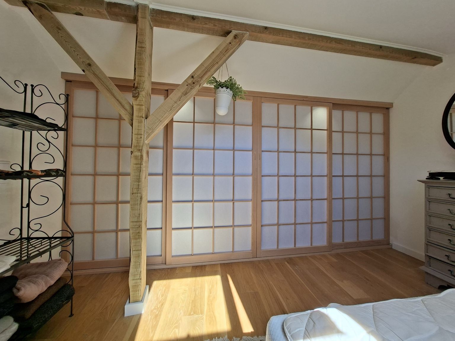 Walnut-framed glass coffee table on a patterned rug in a living room